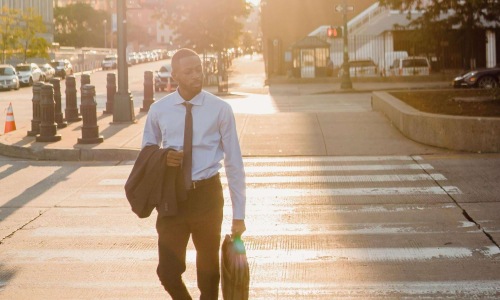 a man walking across the crosswalk