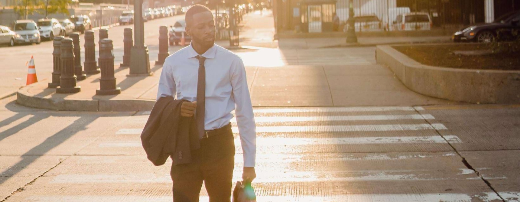 a man walking across the crosswalk