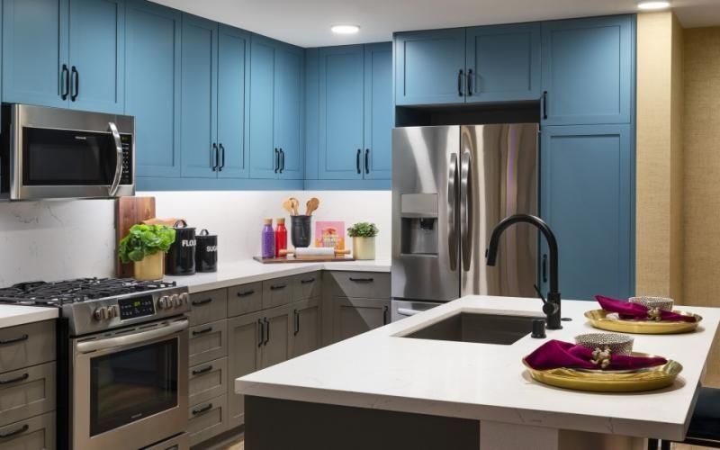 a kitchen with blue cabinets