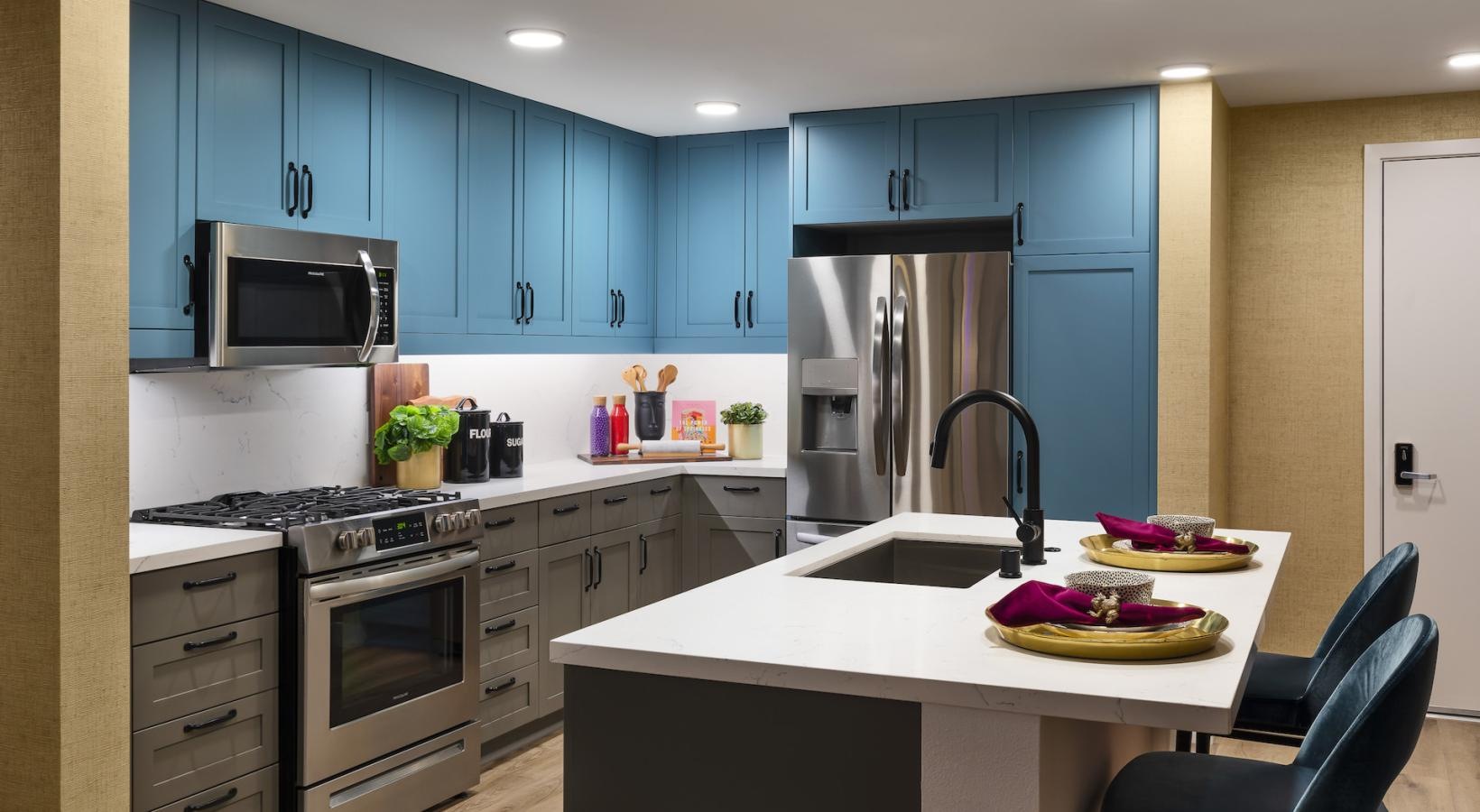 a kitchen with blue cabinets