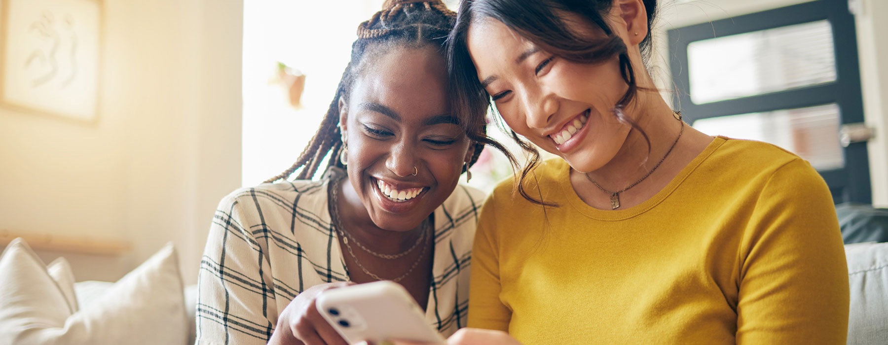 two young women looking at a phone