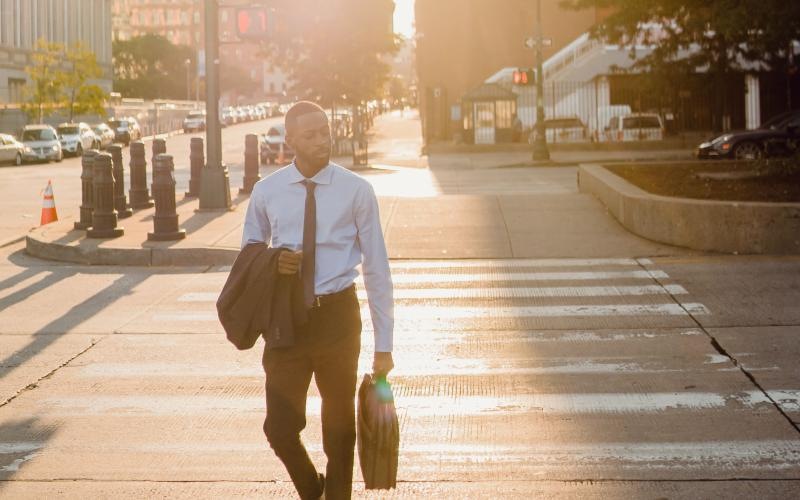 a man walking across the crosswalk